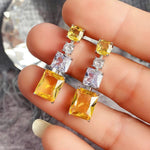 Silver Plated American Diamond Studded Yellow Geometrical Crushed Ice Cut Drop Earrings - Aurvi